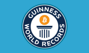Guiness World Records sign with Bitcoin on the poduim