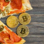 Pizza with a slice missing and Bitcoin coins in its place